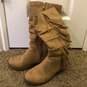 Tan colored tall boots with fringe